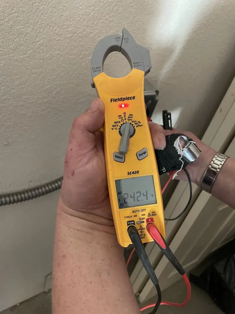 Voltage testing with clamp meter during Recessed Lighting Installation in North Branch